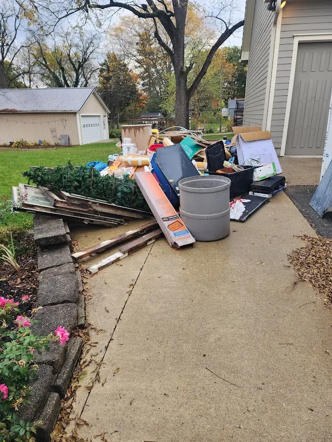 Dumpster being loaded with debris for Estate Cleanout Dumpster Rental in Bradfordville